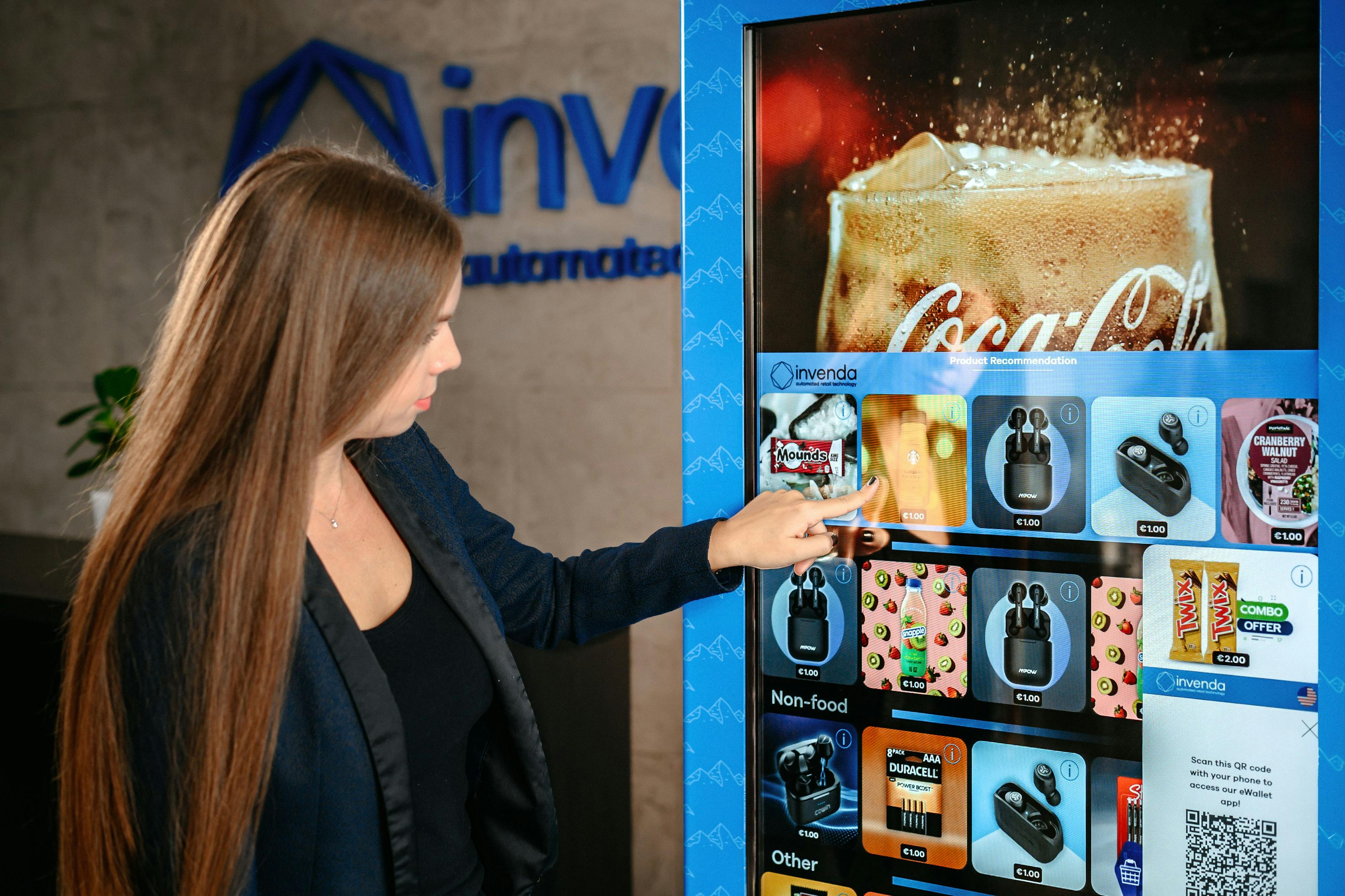 A woman selecting a product on a digital vending machine